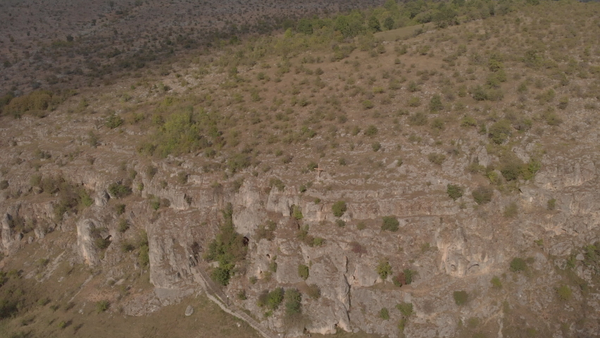 A large cross on top of a mountain from a height