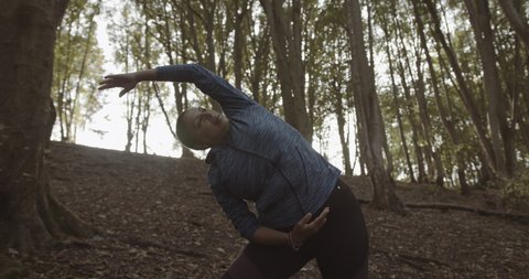 Body positive black female Yoga exercise outdoors, Plus size overweight black woman meditating in forest