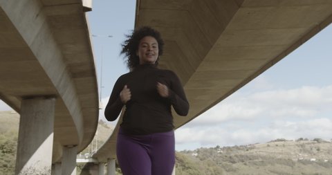 Body positive black female running exercising outdoors, Plus size overweight black woman sports training