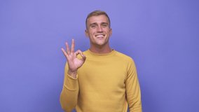 Young caucasian man cheerful and confident showing ok gesture