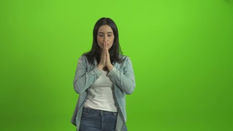 Sad worried young woman having psychological problem. Girl feeling anxious and feeling upset and frustrated on green screen chroma key background
