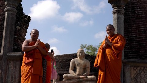 Polonnaruwa, Sri Lanka - 2019-03-23 - Monks On Tour 9 - Posing With Buddha Statue Standing.