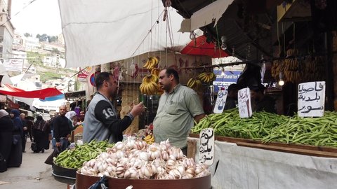 Amman, Jordan - 2019-04-18 - Garlic Street Vendor Talks To Customer.