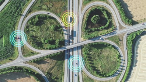 Autonomous driving concept visualized with overlay graphics. Top down aerial of self-driving cars.