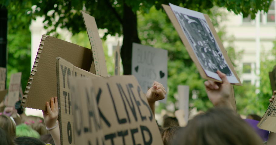 Black Lives Matter Protest in Europe after George death in USA. Solidarity Demonstration with Signes against Police Brutality and Injustice. Crowds of People Gathering for Racial Equality Royalty-Free Stock Footage #1060528978