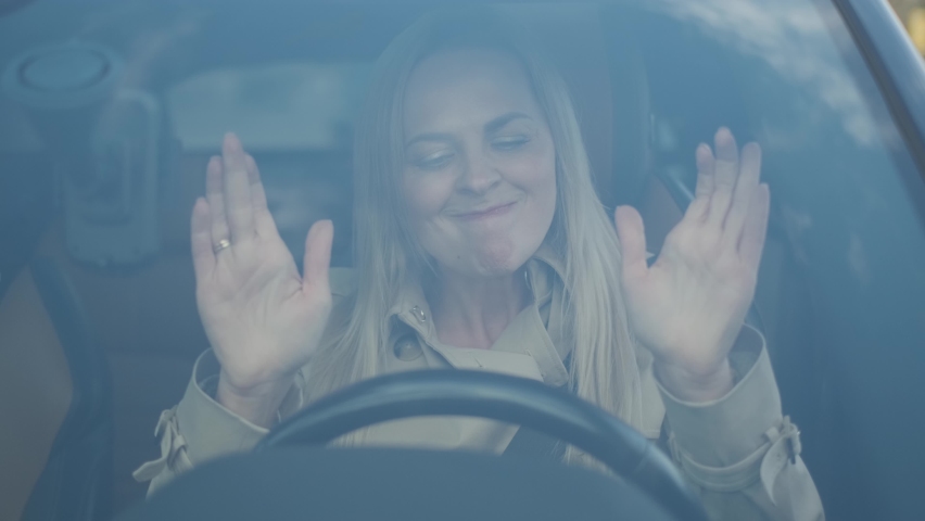 The stressed woman driver is sitting inside her car. Sad business woman is having headache has to make a stop after driving car in traffic jam on rush hour. Exhausted, overworked driver concept. | Shutterstock HD Video #1060529974