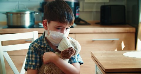 The boy measures the temperature of his friend a teddy bear, and is very surprised that it is high and the friend is sick