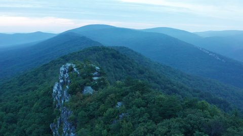 An aerial shot (counter-clockwise orbit) of Big Schloss, Great North Mountain and the Trout Run Valley at dawn in the summer, located on the Virginia/West Virginia Border.