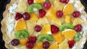 Top view of cake with fresh fruit and berries with cream rotates on tray. Holiday treat. Food dessert background. Bakery and pastry shop concept - Powered by Shutterstock - Get 15% off with code: PIKWIZARD15