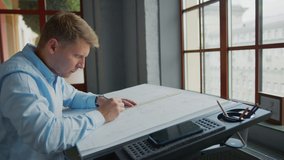 Working man drawing construction plan in office