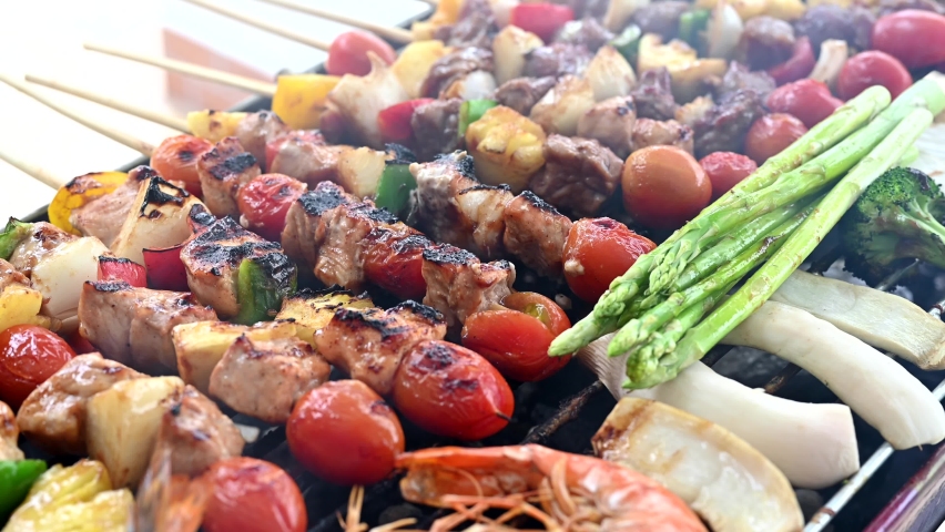 Grill and Barbecue party at home. Cooking BBQ pork, beef, chicken, seafood and vegetables. Family lifestyle and friend outdoor activity. | Shutterstock HD Video #1060540213