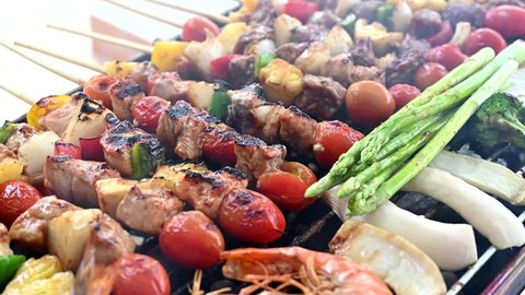 Grill and Barbecue party at home. Cooking BBQ pork, beef, chicken, seafood and vegetables. Family lifestyle and friend outdoor activity.