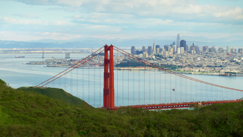 Flying over the Marin Headlands to discover the Golden Gate Bridge. San Francisco, US. This suspension bridge is one of the most iconic landmarks of California. Shot on Red weapon 8K.