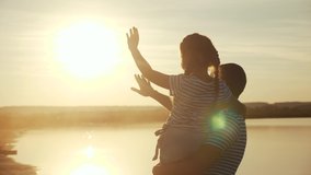 happy family. dad and daughter by the sea at sunset silhouette. father and child kid reach out to the sun. kid dream concept. happy family little girl and dad alone with nature relax sunset concept - Powered by Shutterstock - Get 15% off with code: PIKWIZARD15