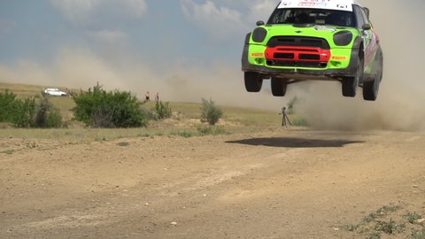 Rally car driving fast in cross-country road. Fast car is going with dust. Speed off-road riding on dusty road.