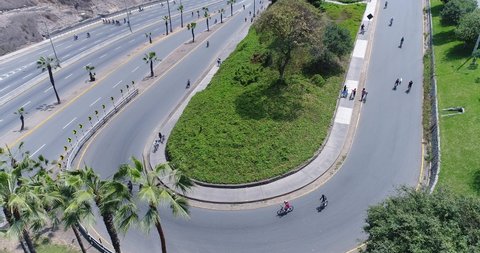 Aerial image made with drone of Lima Peru during sundays. No private cars allowed due to covid19 pandemic curfew. People cycling direction to the beach. Miraflores district.