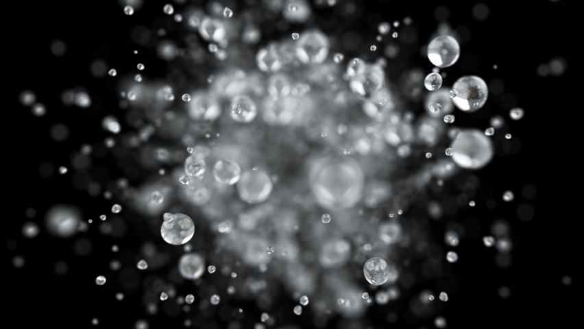 Explosion of water droplets into the camera in slow motion on an isolated black background. Royalty-Free Stock Footage #1060558741
