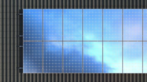 Solar panels modules on roof on a cloudy day. Clouds reflecting on solar panels - 4k