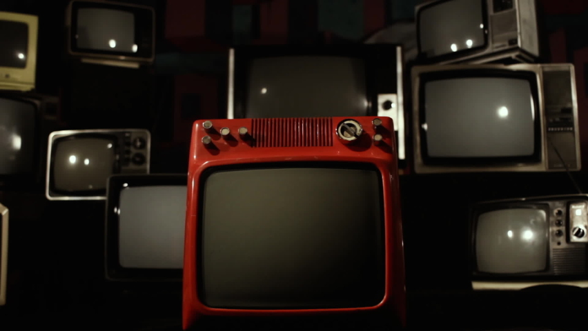 Stack of Old TVs with Color Bars and Retro Red TV with Green Screen. Zoom In. You can replace green screen with the footage or picture you want. You can do it with “Keying” effect in After Effects. Royalty-Free Stock Footage #1060571314