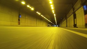 Time lapse night video of tunnel taken by stabilised camera attached to motorcycle as seen from lowest possible asphalt perspective 