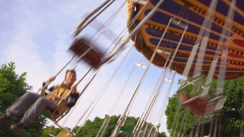 the carousel of the chain is spinning in the amusement Park. family ride a swing at a fun weekend fair or festival with their children. strolls.