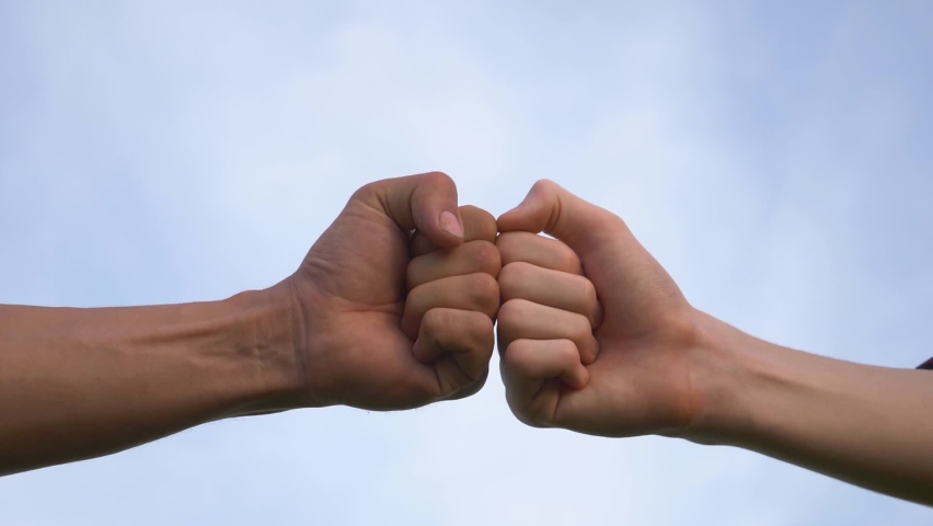 Teamwork. Bumping fists is an expression agreement and friendship. People odifferent nationalities helping hand.Teamwork in business. People odifferent skin colors. Bumping fists helping hand symbol Royalty-Free Stock Footage #1060579273