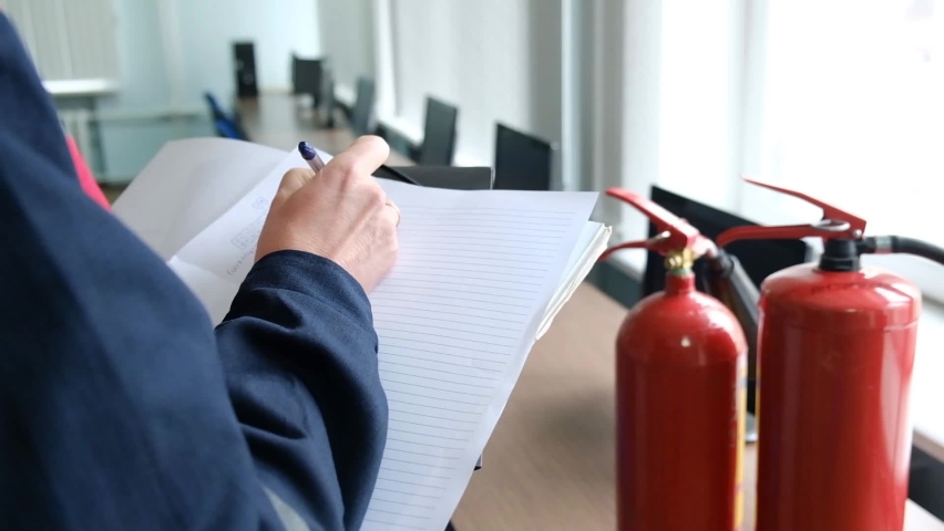 Engineer Professional are Checking A Fire Extinguisher and writes data to the check log. Fire Alarm controller.System ready In the event of a fire. Royalty-Free Stock Footage #1060584886