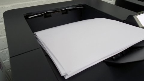 Office laser jet printer printing a lot of pages paper of A4 or letter size in a storehouse - 19th of September 2019