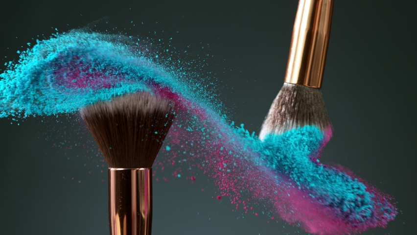 Makeup brushes touch each other on dark background and small particles of cosmetics, super slow motion, 1000 fps. Royalty-Free Stock Footage #1060587187