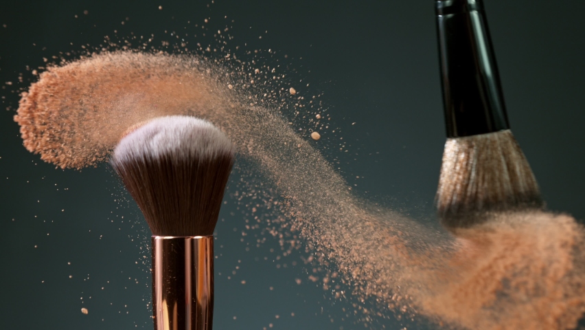 Makeup brushes touch each other on dark background and small particles of cosmetics, super slow motion, 1000 fps. | Shutterstock HD Video #1060587190