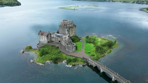 Striking Aerial View Of The Famous Eilean Donan Castle In The Small Tidal Island Of Donnan, Western Highlands Of Scotland - drone pullback shot