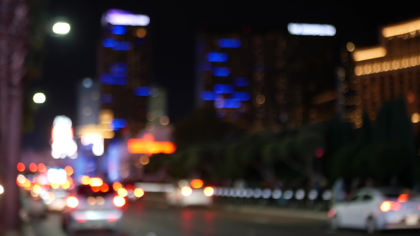 Defocused fabulous Las Vegas Strip boulevard, luxury casino and hotel, gambling area in Nevada, USA. Nightlife and traffic near Fremont street in tourist money playing resort. Neon lights of sin city.