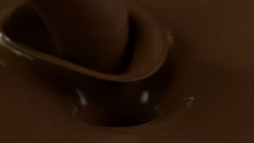 Super slow motion of blanched hazelnuts falling into molten chocolate. Filmed on high speed cinema camera, 1000 fps. Royalty-Free Stock Footage #1060591018