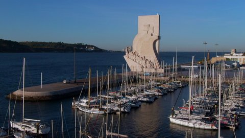 Lisbon, Portugal - October 12, 2020: Aerial view of Belem harbour and Discoveries monument (Portuguese: Padrao dos Descobrimentos ) on the northern bank of the Tagus River in Lisbon, Portugal. 