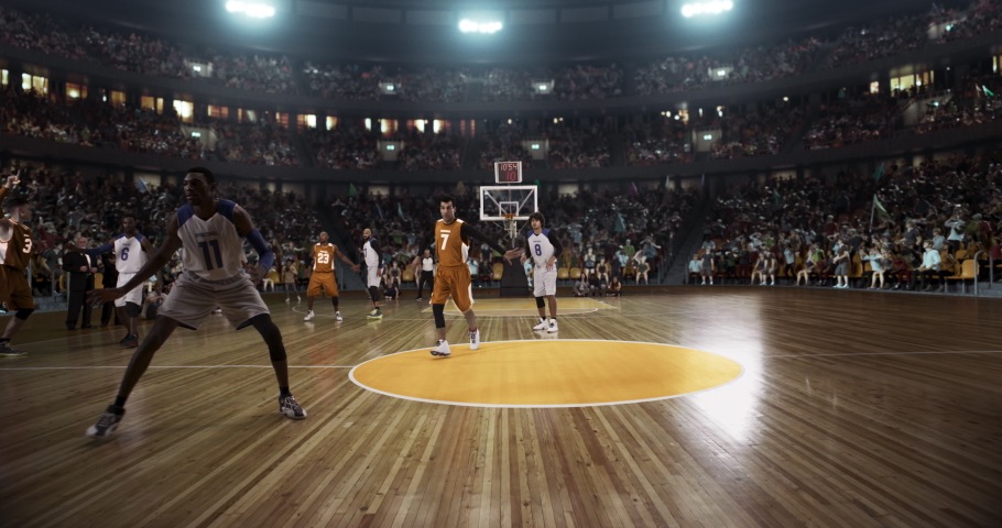 Basketball player scores a goal on a professional basketball stadium. Stadium is made in 3d with animated crowd. Dynamic shot. Royalty-Free Stock Footage #1060591846