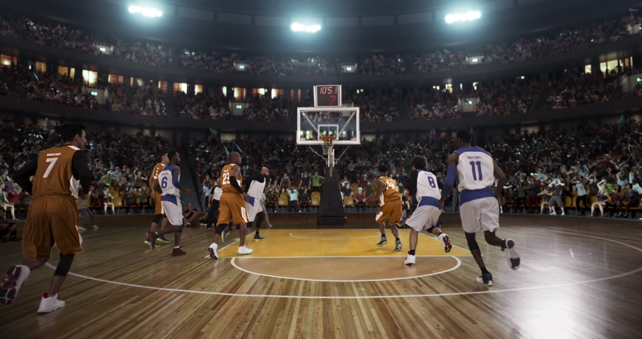 Basketball player scores a goal on a professional basketball stadium. Stadium is made in 3d with animated crowd. Dynamic shot. | Shutterstock HD Video #1060591846