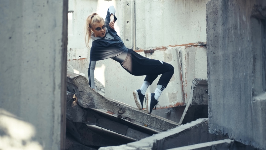 Girl dancer posing on the ruins.