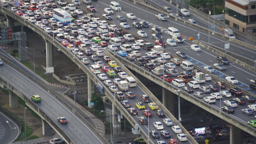Aerial view of busy cars with traffic jam in the rush hour on highway road street on bridge in Bangkok Downtown, urban city in Asia, Thailand at sunset. Intersection junction. Toll gate in Rama 9 | Shutterstock HD Video #1060594963
