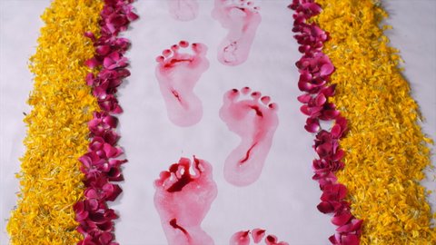 A newly married woman's red footsteps symbolic to the arrival of Goddess Lakshmi. Closeup shot of red footprints of an Indian bride entering her husband's home for the first time - Griha Pravesh co...