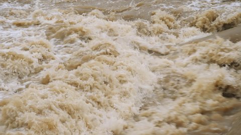 Rivers flood. Crowded river overflows its banks. Raging river with dirty water. Disaster flood deluge and water flow after rainfall.