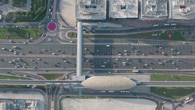 Amazing aerial view overhead of ten lanes major highway in Dubai. Cars and metro trains moving during rush hour traffic, on Sheikh Zayed Road; Top Angle zooming in video