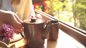 4K video woman dip and mix tea in cup on wooden table at  chinese restaurant