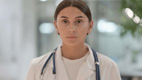 Portrait of Serious Female Doctor doing Video Call 