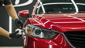 Car service worker applying nano coating on a car detail. - Powered by Shutterstock - Get 15% off with code: PIKWIZARD15