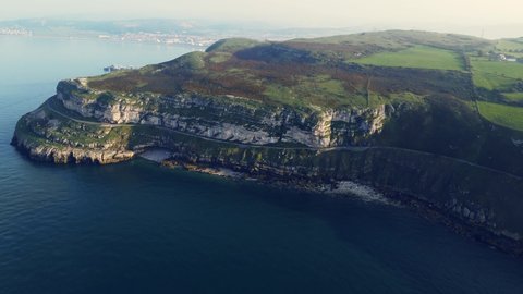 Drone hovering about the great Orme mountain revealing Llandudno behind