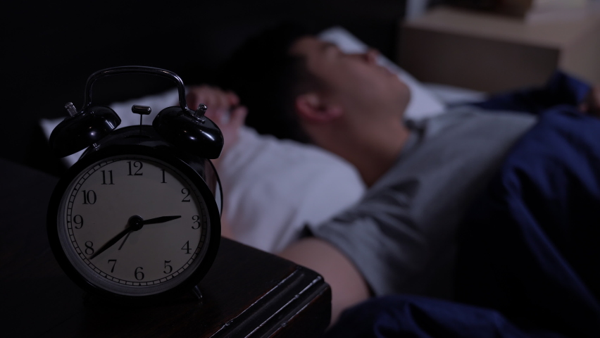 Depressed young Asian man cannot sleep from insomnia. Depressed man suffering from insomnia lying in bed. | Shutterstock HD Video #1060620562