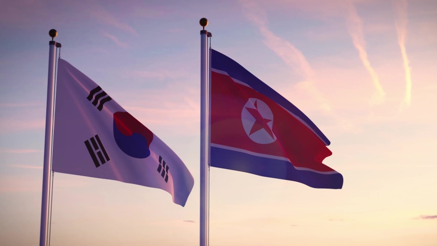 South and North Korea flags show the tension and confrontation between Seoul and pyongyang. Korean crisis on the DMZ and from nuclear missiles. Royalty-Free Stock Footage #1060622272