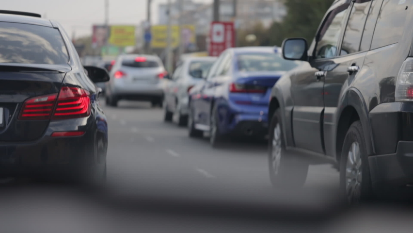 Dense city traffic, cars are moving slowly, traffic jam | Shutterstock HD Video #1060625362