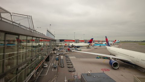 QINGDAO, CHINA - SEPTEMBER 16 2019: cloudy day airplanes connected to qingdao airport terminal getting ready for departure timelapse panorama 4k circa september 16 2019 qingdao, china.