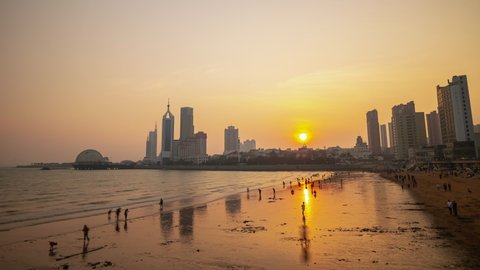 QINGDAO, CHINA - SEPTEMBER 16 2019: sunset sky qingdao city famous crowded beach timelapse panorama 4k circa september 16 2019 qingdao, china.